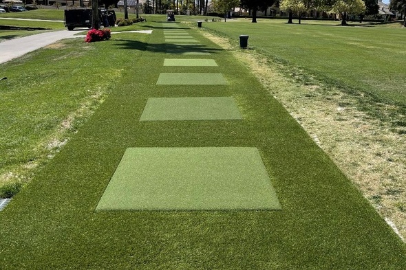 Augusta Outdoor tee line with light green synthetic grass boxes inside a dark green synthetic grass strip